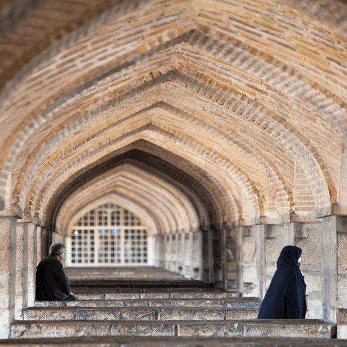 People sitting in arches